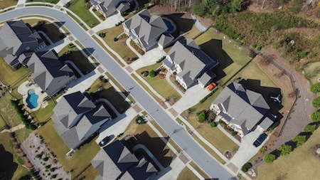 Technician pressure washing Orlando HOA sidewalks